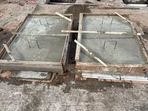 Two concrete slab panels cast in timber formwork